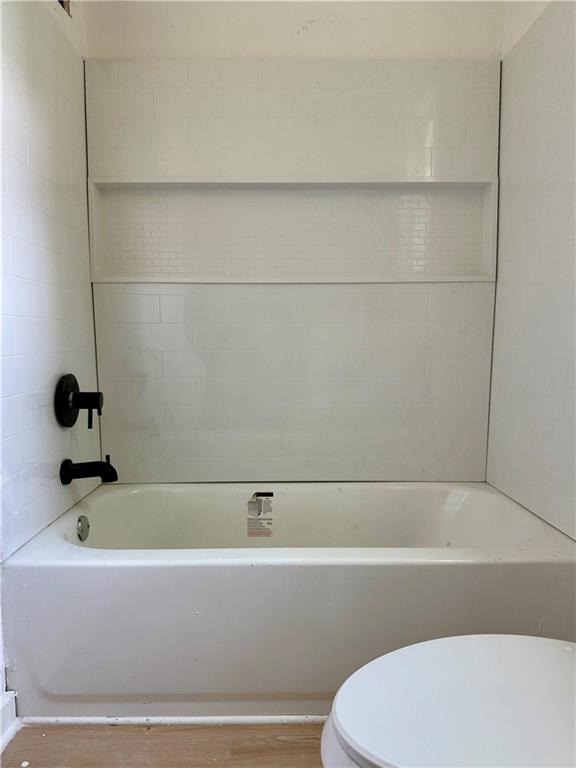 808 Center Street Macon, GA 31217 - Photo 24 of 30 a bathroom with a bathtub and toilet