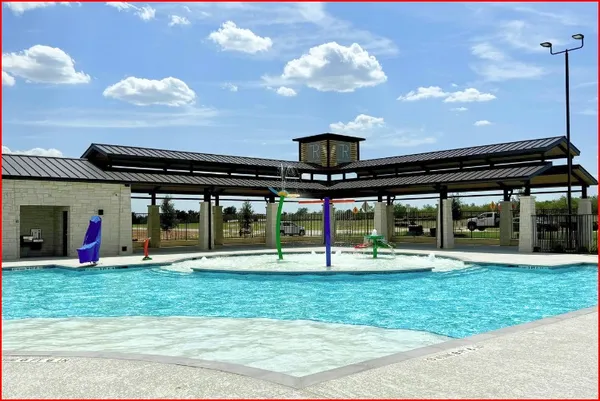 a view of a swimming pool with an outdoor seating