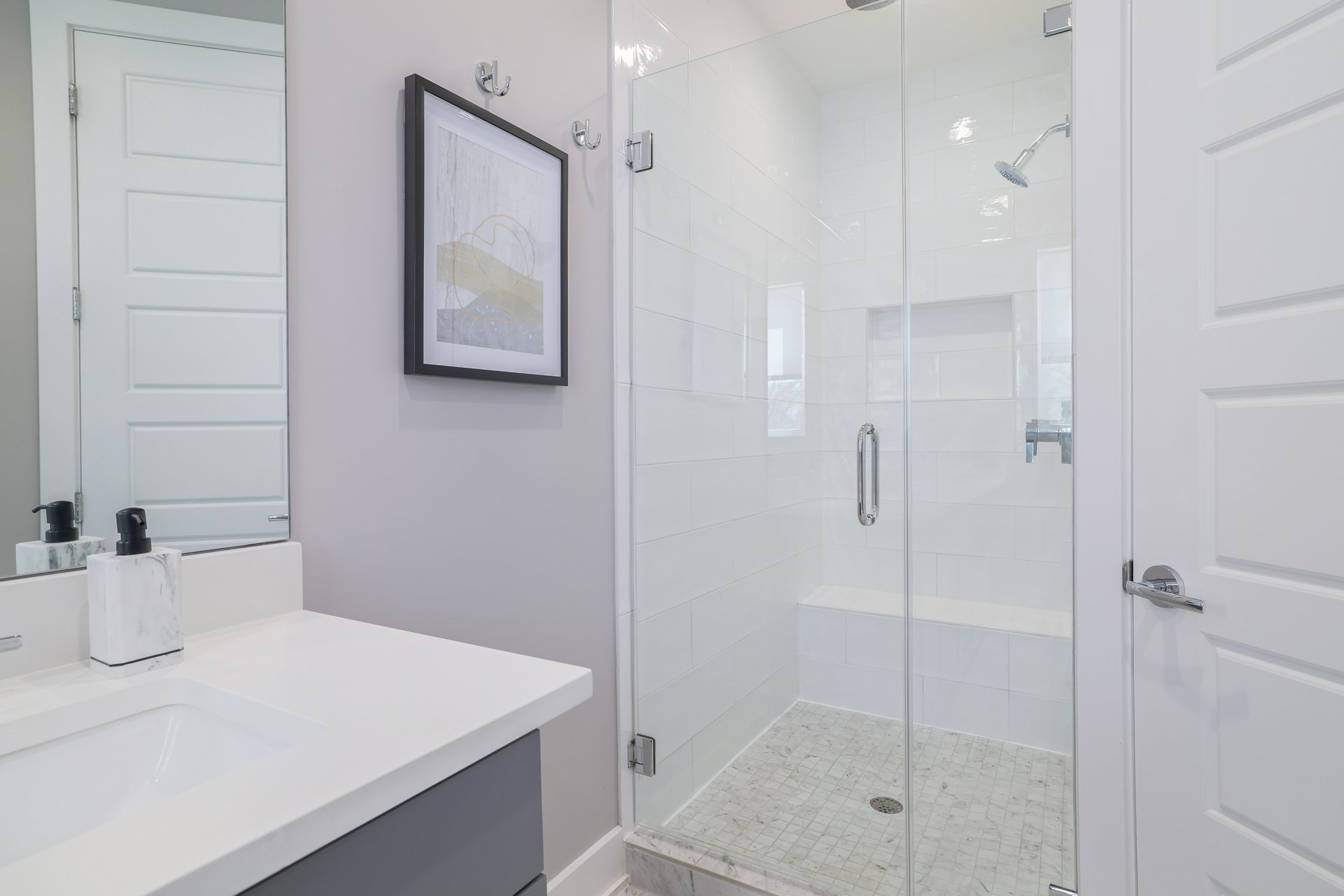 1103 Saucedo Street, Unit B Austin, TX 78721 - Photo 16 of 26 A dedicated walk-in shower with updated tile work provides a clean, modern look in the primary ensuite