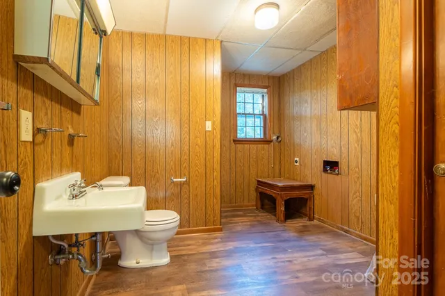 a bathroom with a sink a toilet and shower curtain