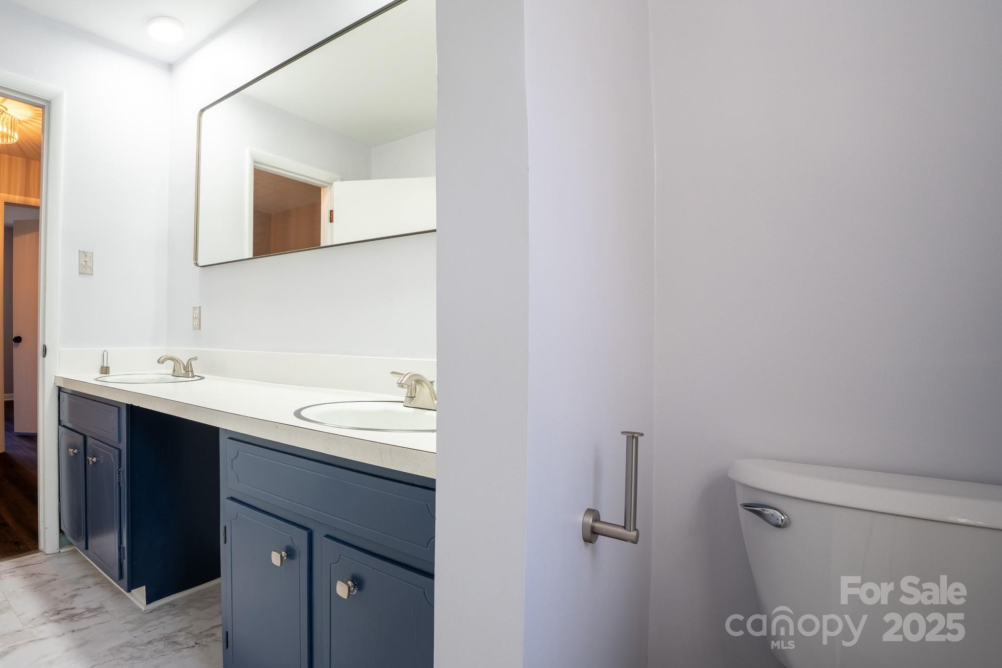 3851 Idlewood Acres Road Hickory, NC 28601 - Photo 17 of 34 a bathroom with a sink mirror and toilet