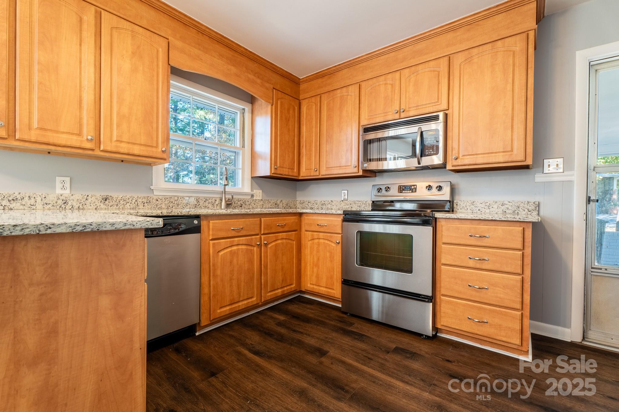 3851 Idlewood Acres Road Hickory, NC 28601 - Photo 8 of 34 a kitchen with stainless steel appliances granite countertop a stove a sink and a microwave