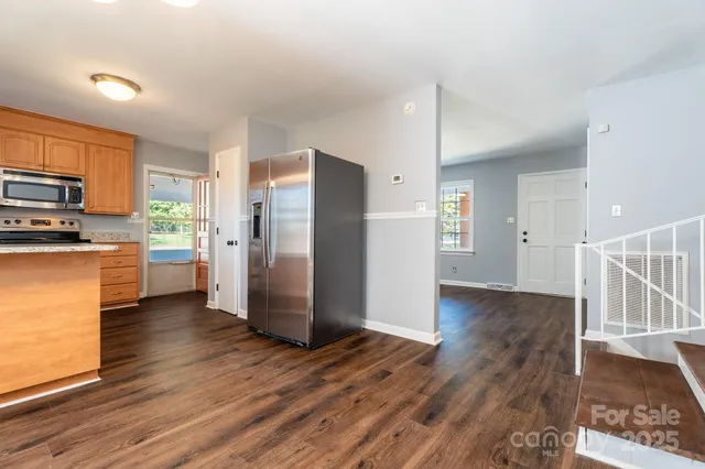 a kitchen with stainless steel appliances a refrigerator and a stove top oven