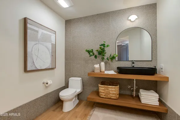 a bathroom with a toilet a sink and mirror
