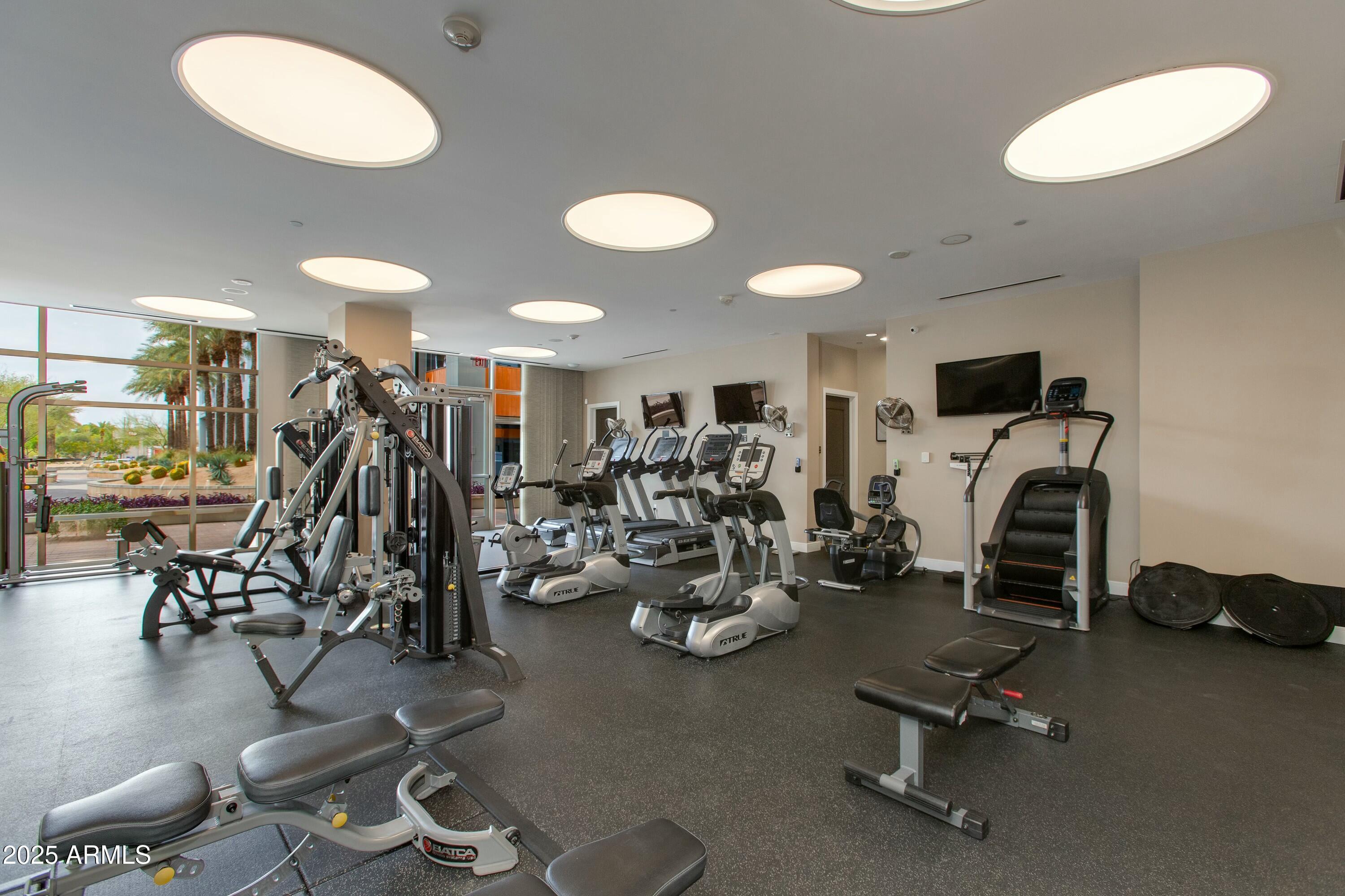 2211 East Camelback Road, Unit 402 Phoenix, AZ 85016 - Photo 18 of 27 a view of a room with gym equipment