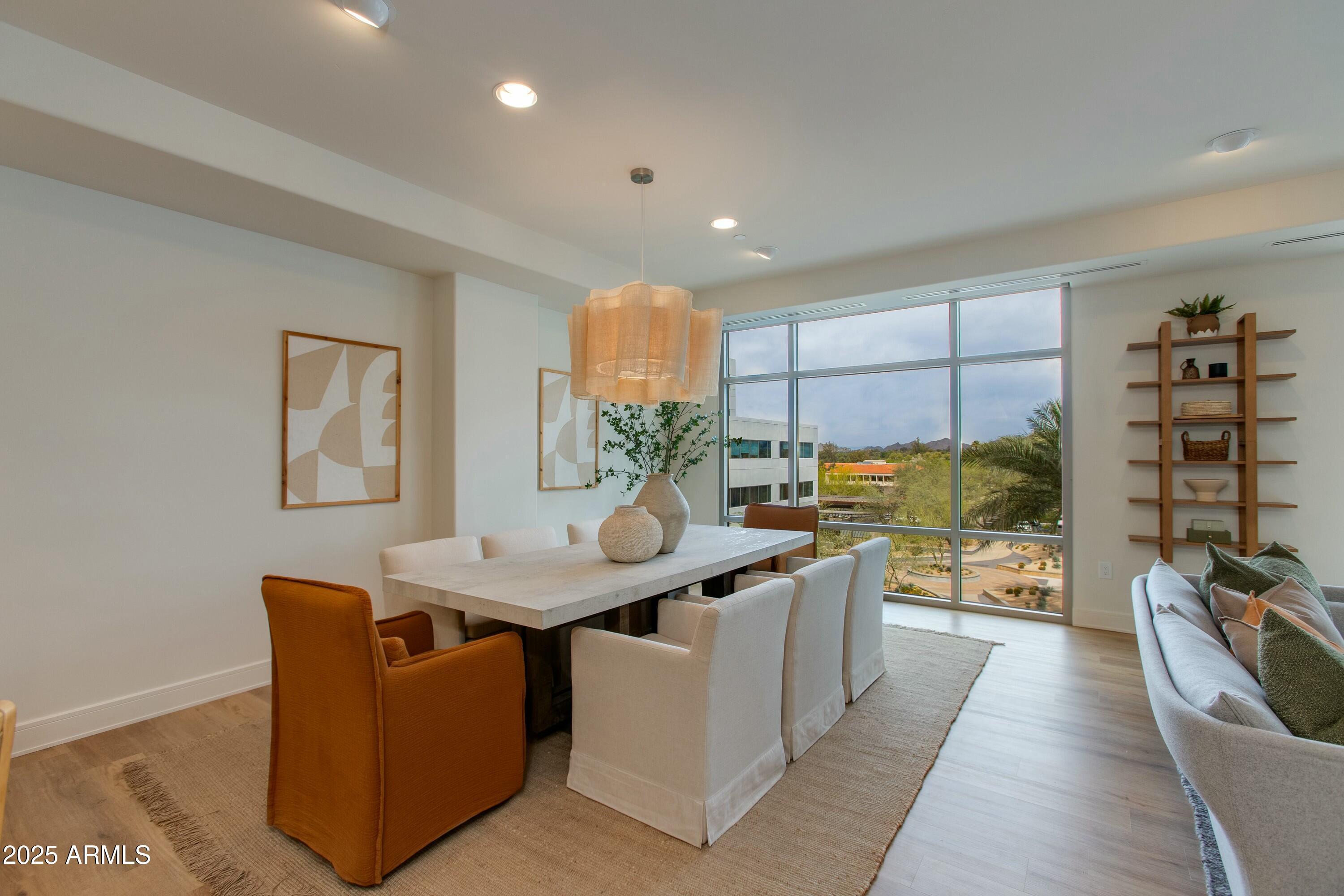 2211 East Camelback Road, Unit 402 Phoenix, AZ 85016 - Photo 4 of 27 a kitchen with stainless steel appliances granite countertop a sink a counter top space and living room view