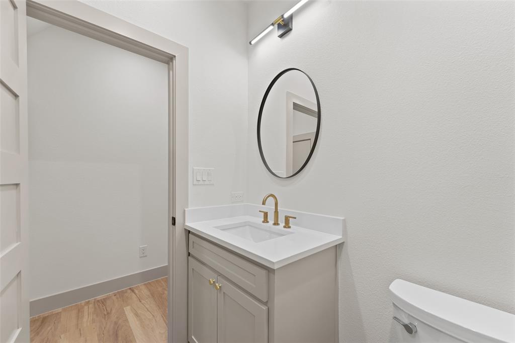 14120 Park Way Log Cabin, TX 75148 - Photo 32 of 40 a bathroom with a sink a toilet and a mirror