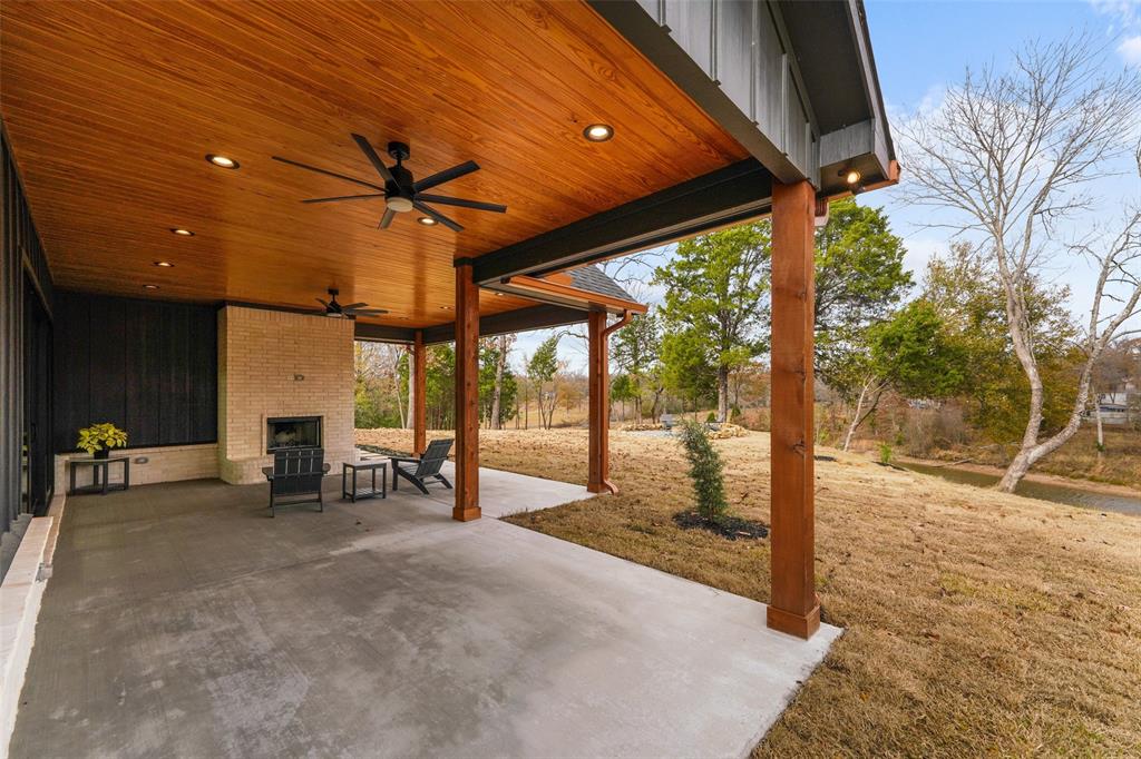 14120 Park Way Log Cabin, TX 75148 - Photo 33 of 40 a view of a patio with table and chairs under an umbrella