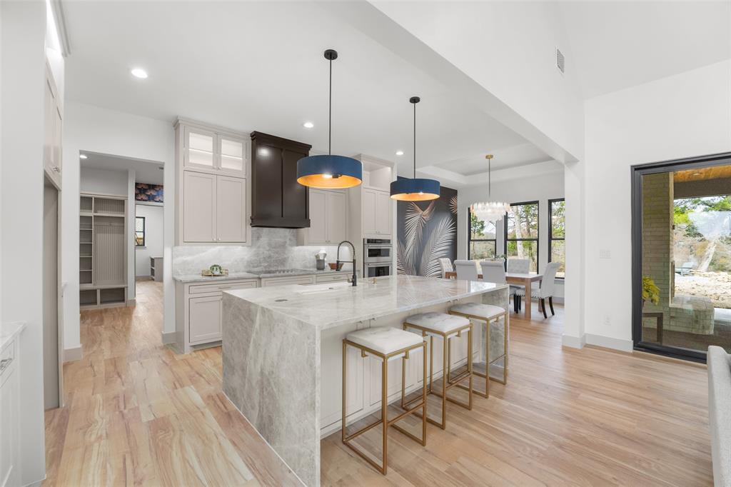 14120 Park Way Log Cabin, TX 75148 - Photo 9 of 40 a open kitchen with stainless steel appliances granite countertop a stove top oven a sink island and a wooden floor
