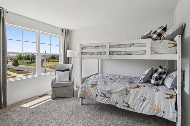 a bedroom with a bed and large window