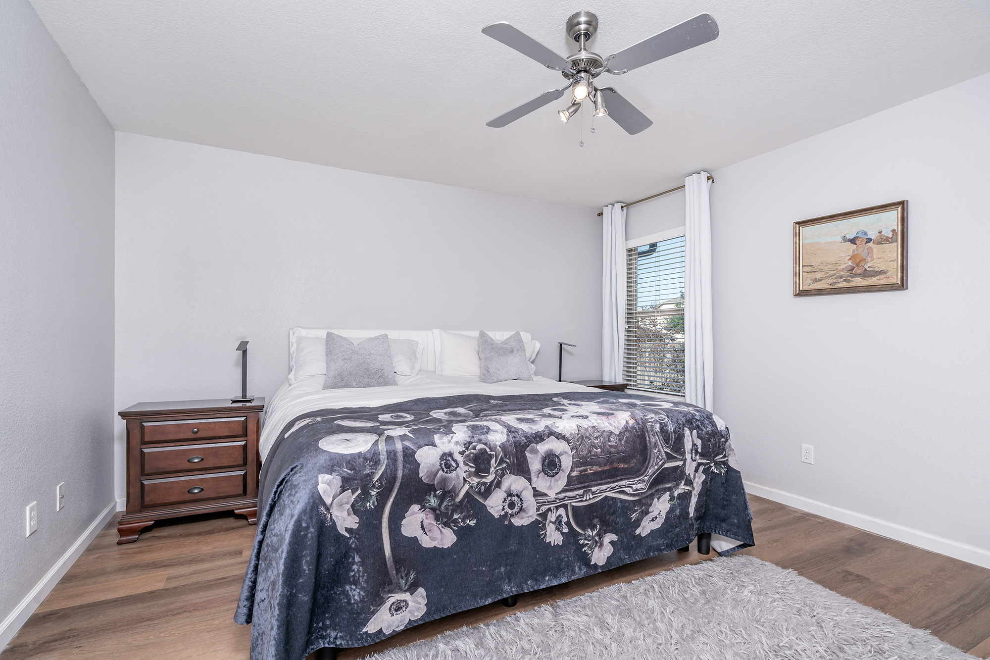 328 Cedar Lake Boulevard Georgetown, TX 78633 - Photo 16 of 34 a bedroom with a bed a dresser and a chandelier