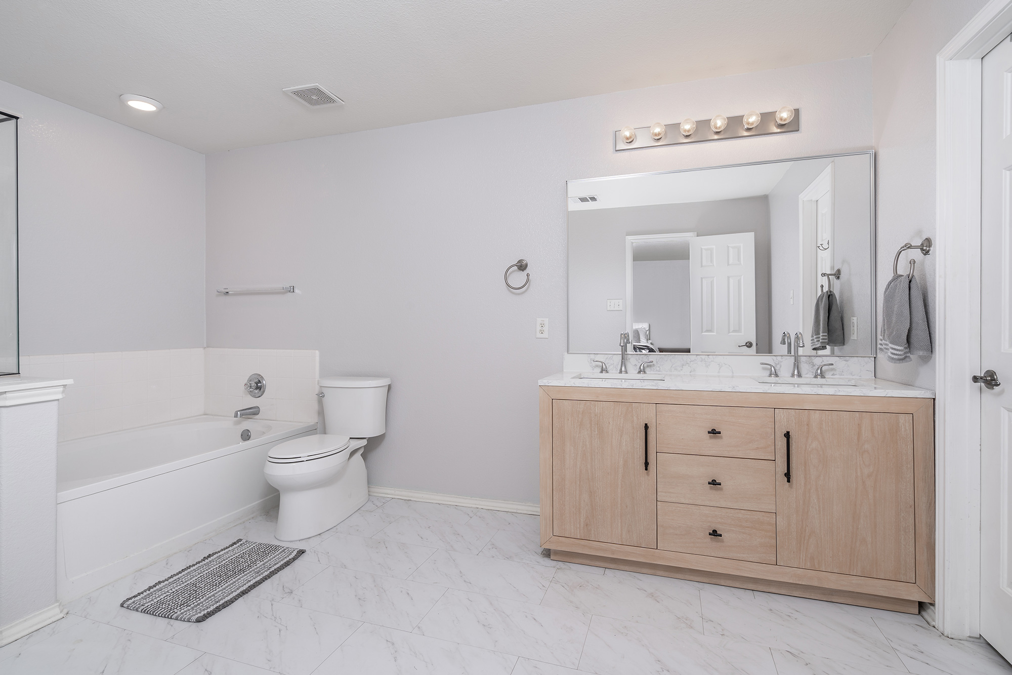 328 Cedar Lake Boulevard Georgetown, TX 78633 - Photo 17 of 34 a spacious bathroom with a double vanity sink a mirror and a bathtub