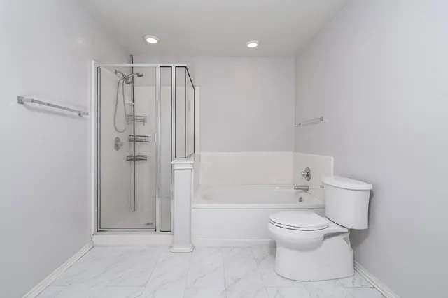 a kitchen with granite countertop wooden floor a center island and stainless steel appliances