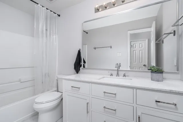 a bathroom with a toilet and shower