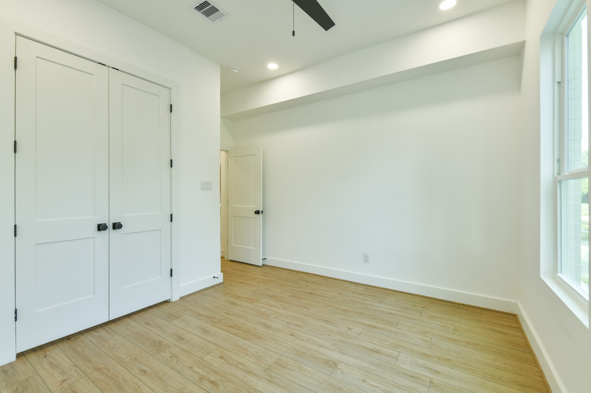 164 Wallace Street Houston, TX 77022 - Photo 19 of 29 a view of an empty room with wooden floor