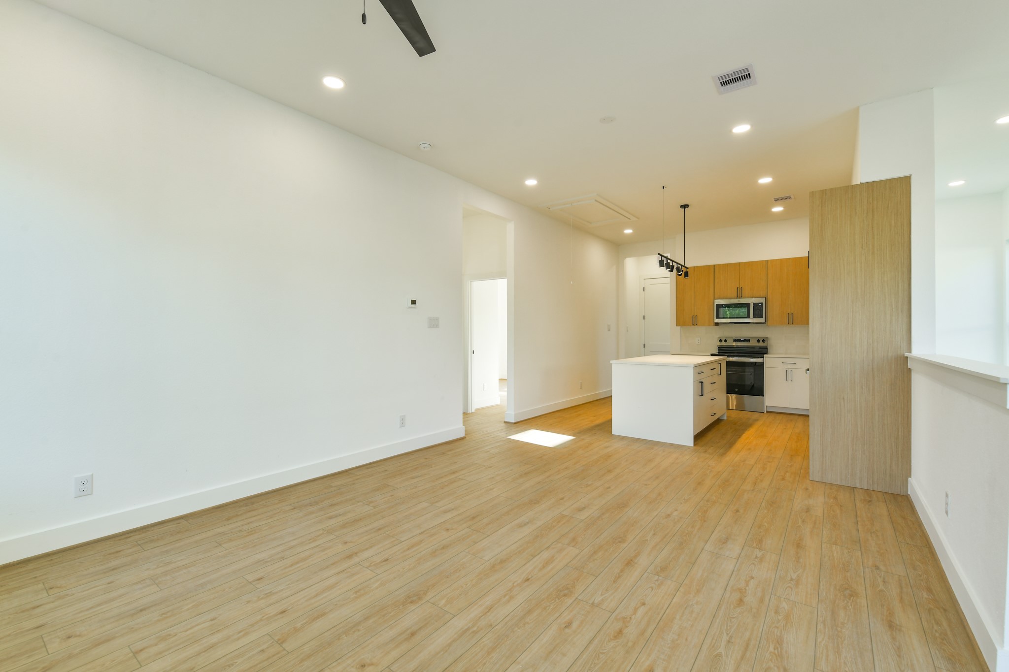 164 Wallace Street Houston, TX 77022 - Photo 27 of 29 a view of a kitchen with kitchen island wooden floor center island and stainless steel appliances