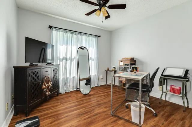 a view of a workspace with furniture and a flat screen tv