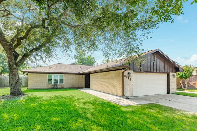 a front view of a house with a garden and yard