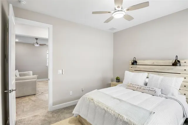 a bedroom with a bed and a chandelier