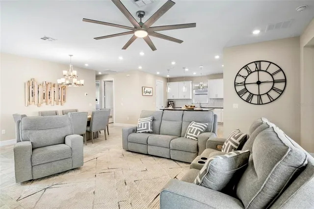 a living room with furniture and kitchen view