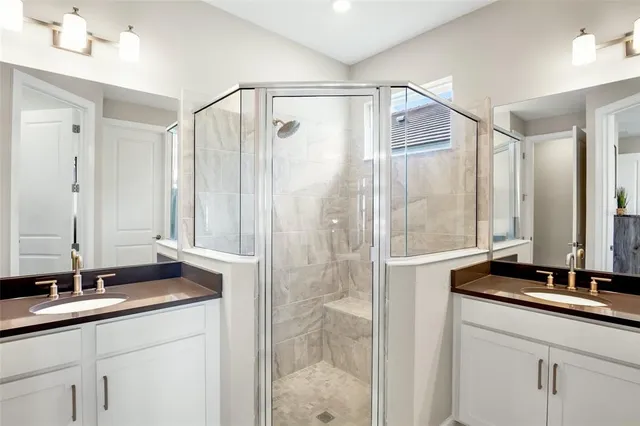 a bathroom with a double vanity sink and a mirror