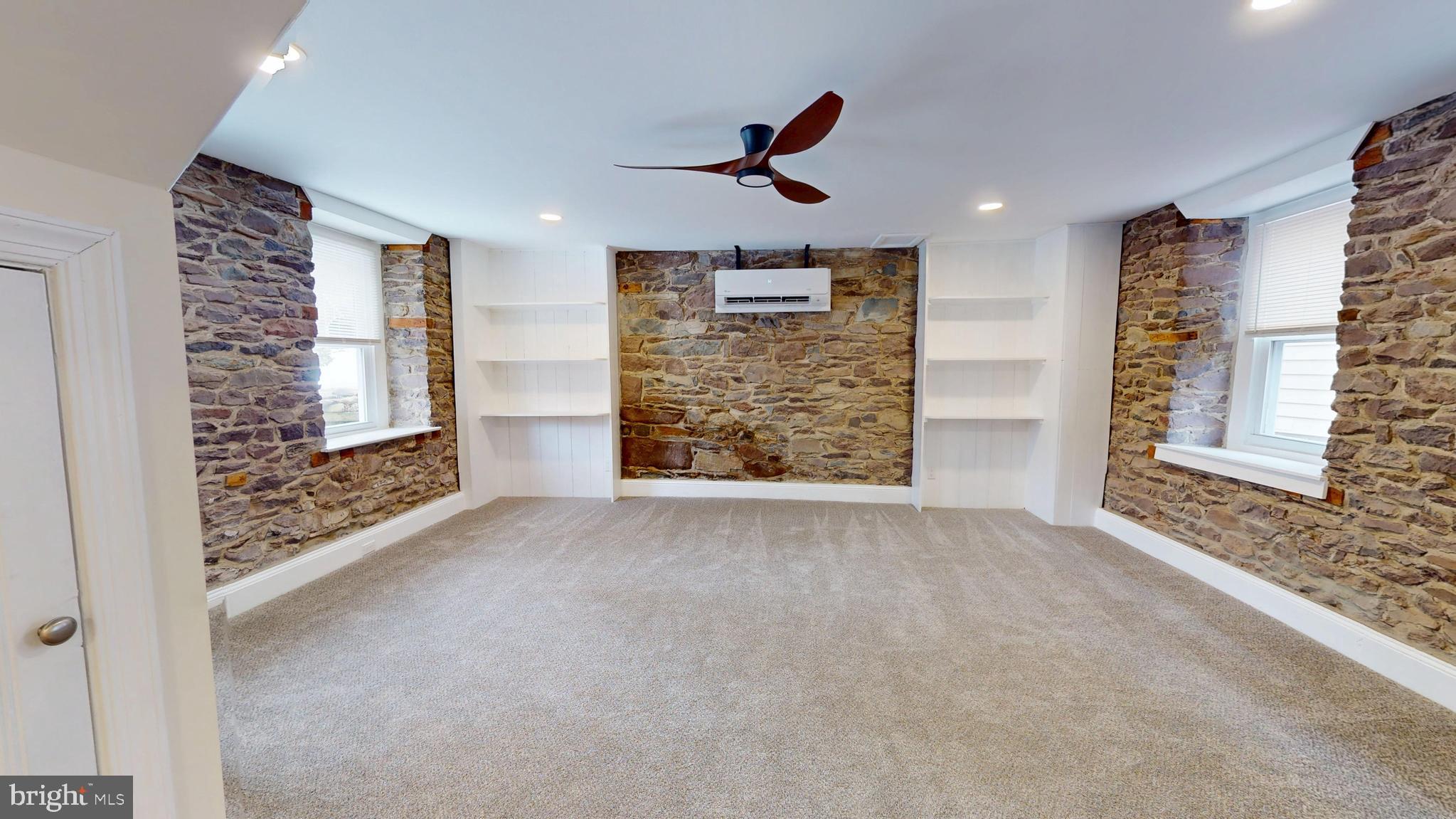 824 Kintner Road Kintnersville, PA 18930 - Photo 13 of 33 en empty room with windows and ceiling fan