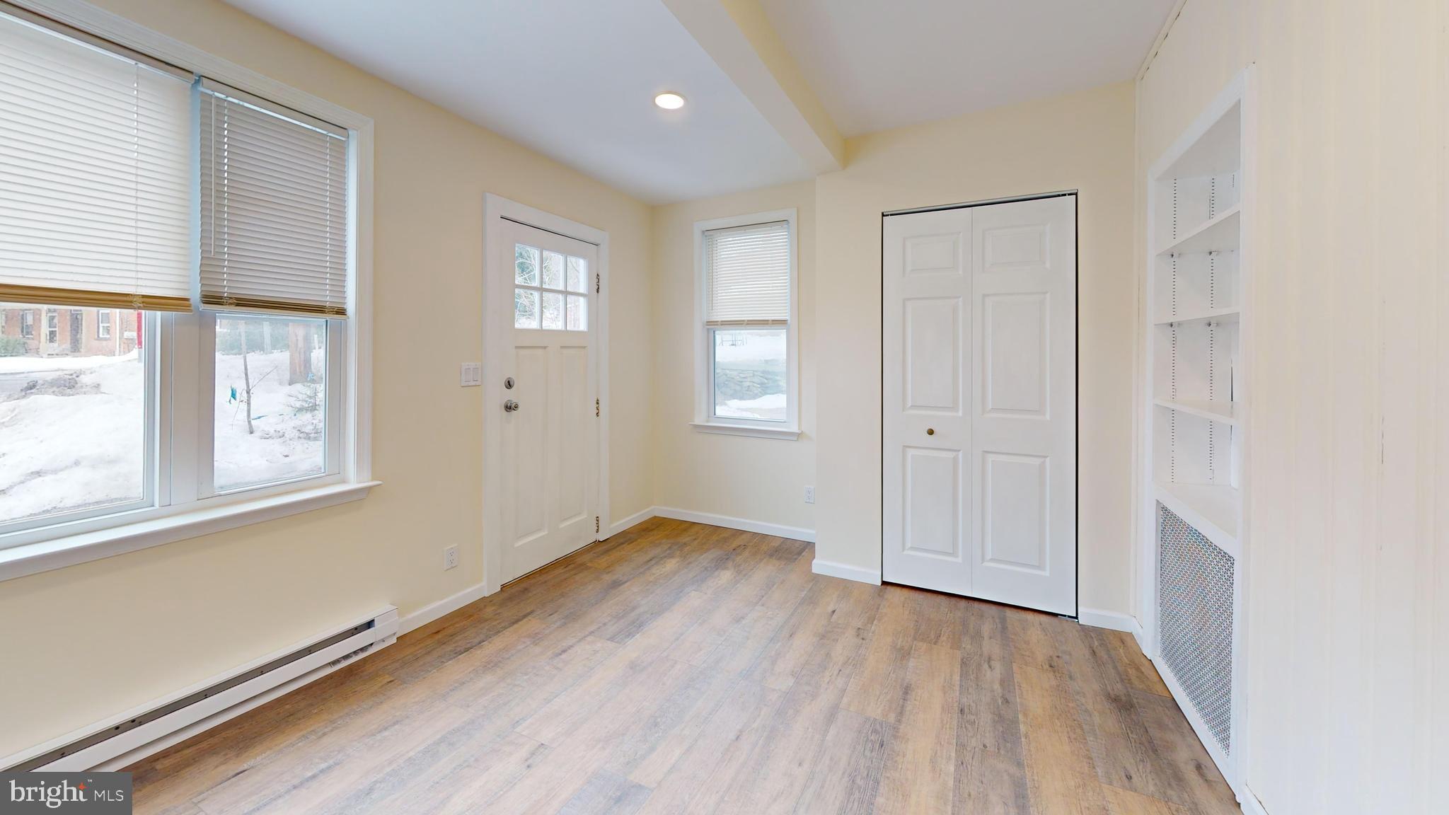 824 Kintner Road Kintnersville, PA 18930 - Photo 4 of 33 an empty room with wooden floor and windows