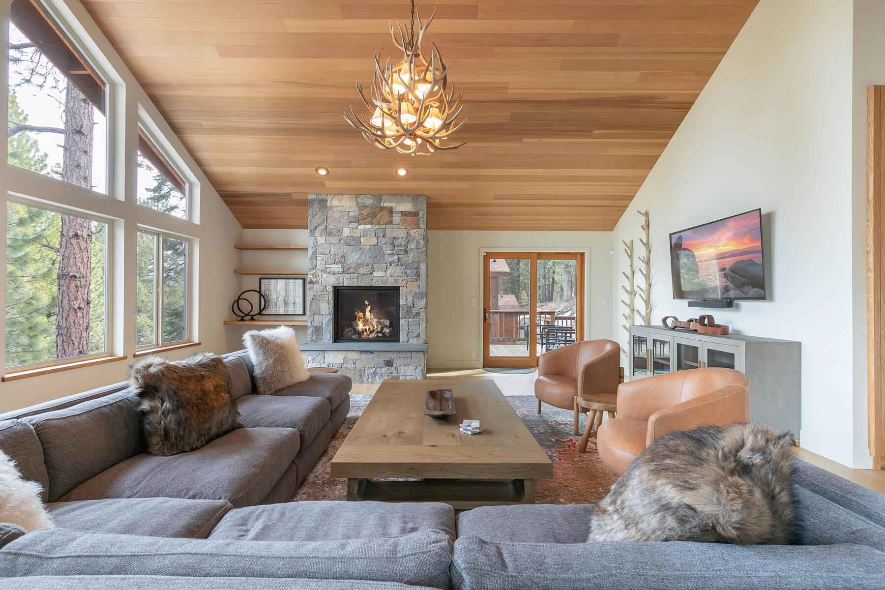 237 Basque Drive Truckee, CA 96161 - Photo 2 of 21 a living room with furniture a fireplace and a flat screen tv