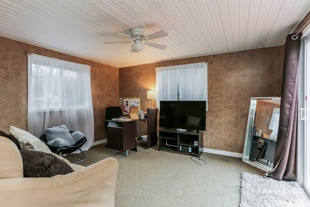 829 River Road Agawam, MA 01001 - Photo 11 of 29 a living room with furniture and a flat screen tv