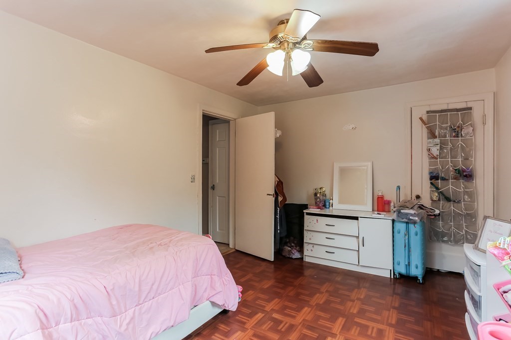 829 River Road Agawam, MA 01001 - Photo 21 of 29 a bedroom with a large bed and a chandelier