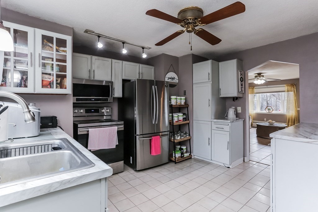 829 River Road Agawam, MA 01001 - Photo 5 of 29 a kitchen with refrigerator cabinets and a sink