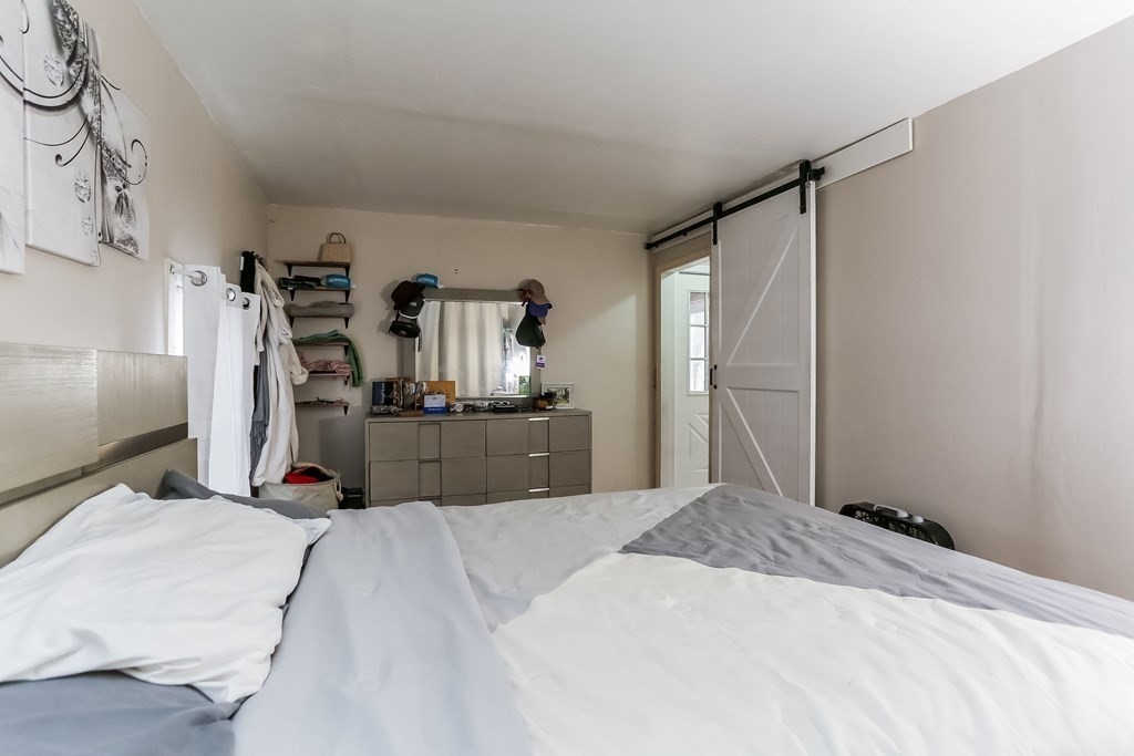 829 River Road Agawam, MA 01001 - Photo 9 of 29 a bed room with a bed and a view of kitchen