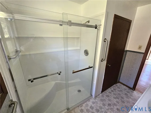 a bathroom with a glass door shower