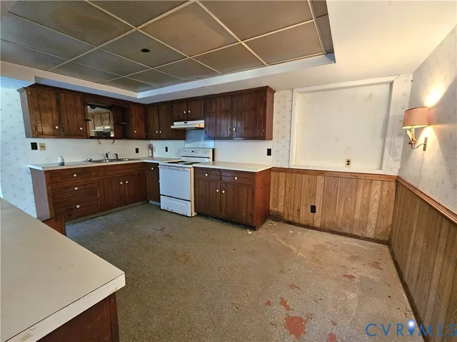 a large kitchen with lots of counter space cabinets and stainless steel appliances