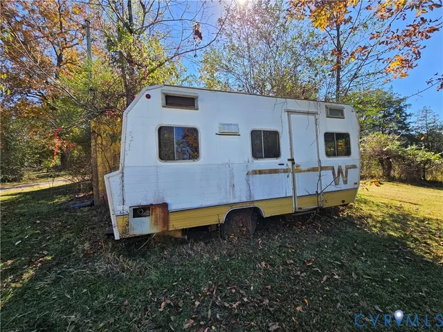 a backyard of a house with wooden fence and porch
