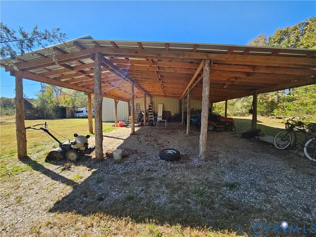 a view of a backyard with table and chairs under an umbrella