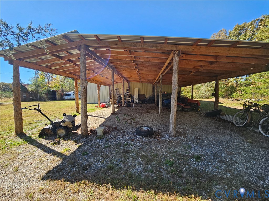 37 Bear Branch Road Farmville, VA 23901 - Photo 30 of 48 a view of a backyard with table and chairs under an umbrella