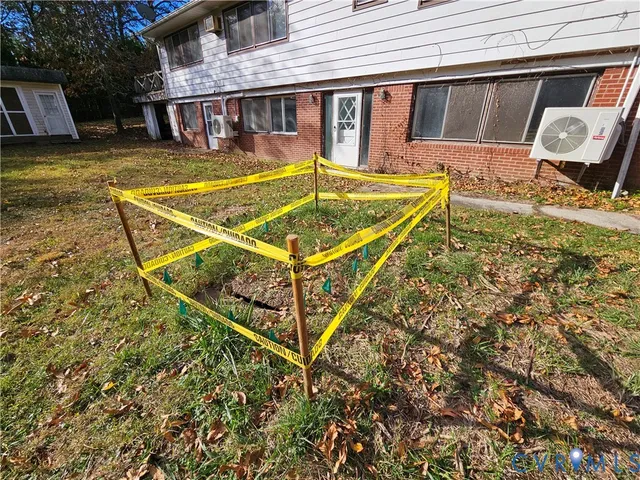 a backyard of a house with table and chairs and potted plants