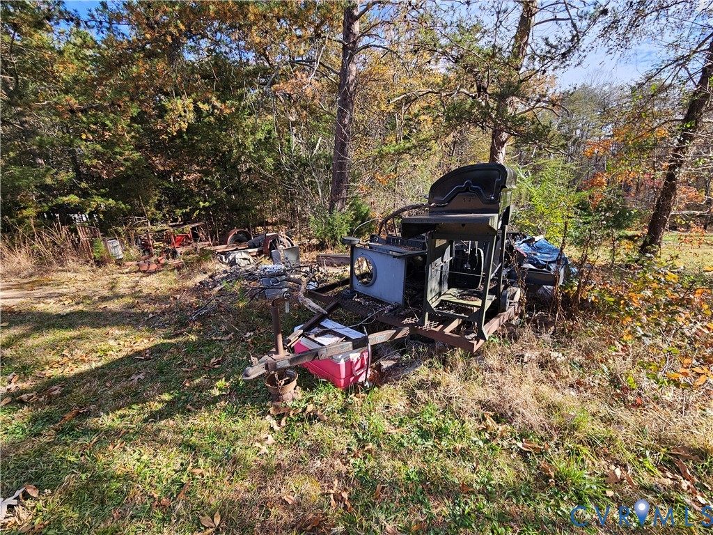 37 Bear Branch Road Farmville, VA 23901 - Photo 43 of 48 a backyard of a house with table and chairs and potted plants
