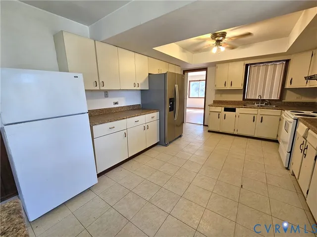 a kitchen with stainless steel appliances granite countertop a refrigerator sink and cabinets