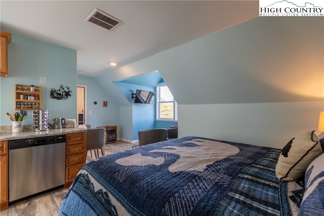 449 Meadow Ridge Drive Jefferson, NC 28640 - Photo 29 of 37 a bedroom with a bed and a dresser in it