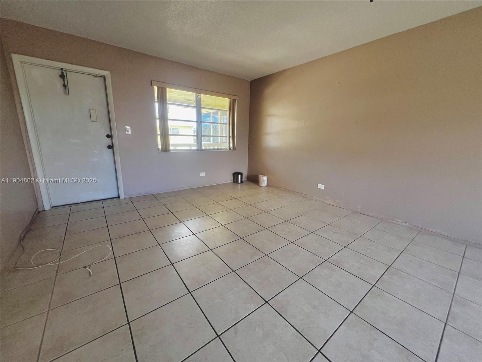 1501 Arthur Street, Unit 9 Hollywood, FL 33020 - Photo 2 of 20 a view of an empty room and a window