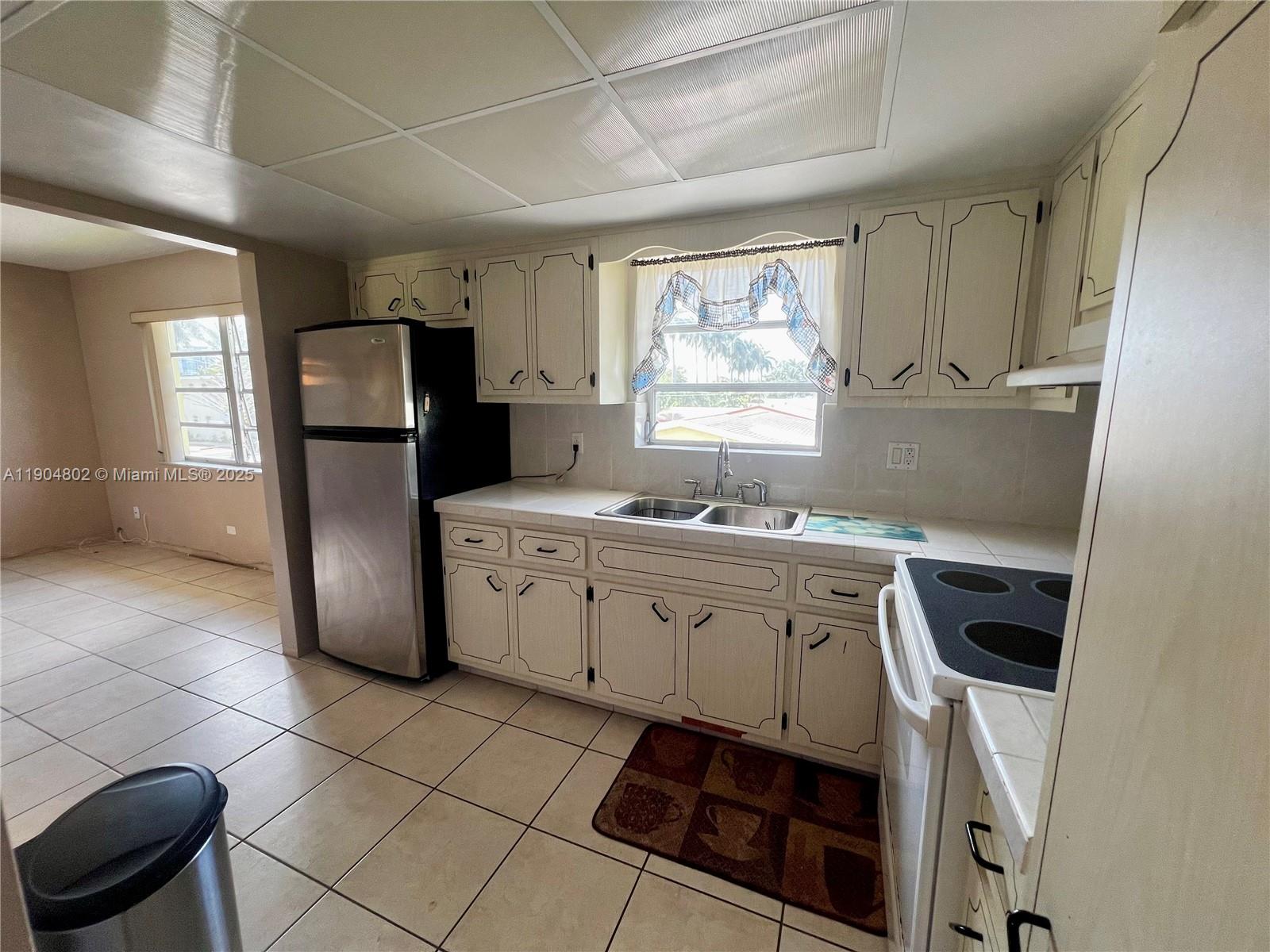1501 Arthur Street, Unit 9 Hollywood, FL 33020 - Photo 6 of 20 a kitchen with a sink cabinets and refrigerator