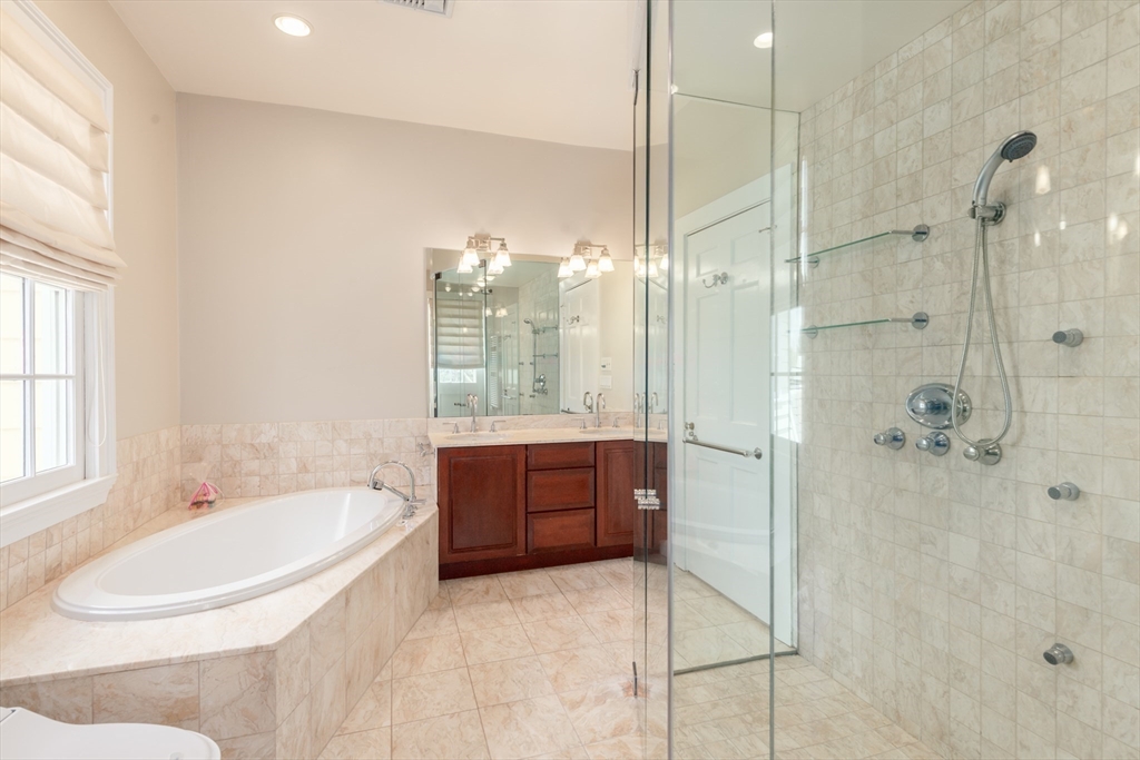 355 Buckminster Road Brookline, MA 02445 - Photo 15 of 32 a bathroom with a bathtub shower sink and mirror