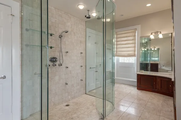 a bathroom with a glass shower door and a sink