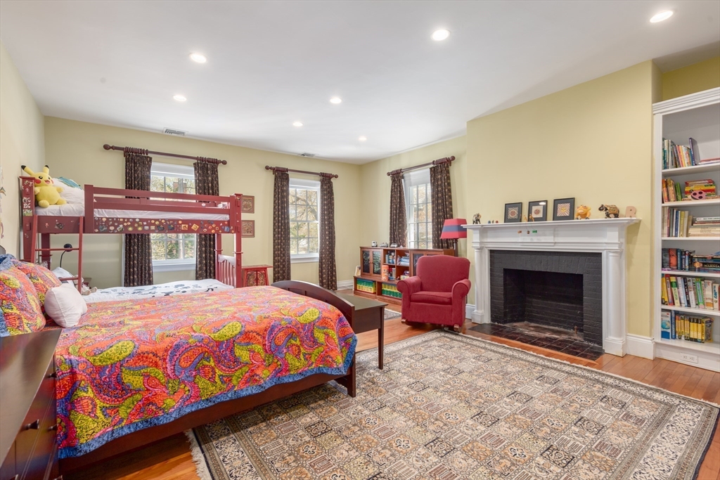 355 Buckminster Road Brookline, MA 02445 - Photo 17 of 32 a bedroom with a bed and a fireplace
