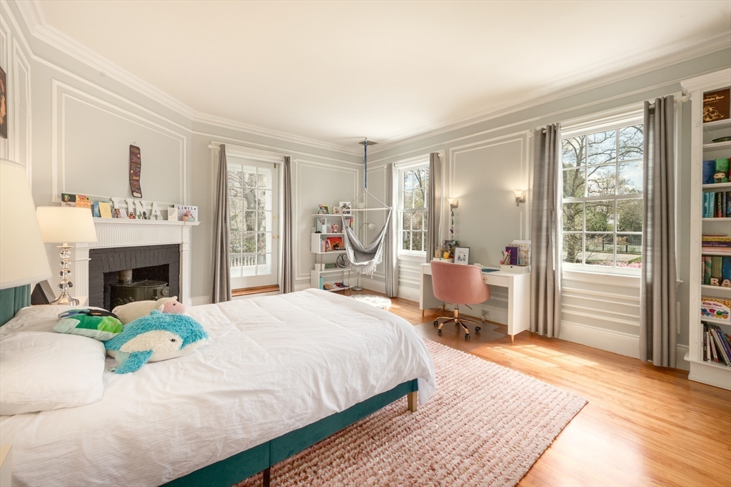355 Buckminster Road Brookline, MA 02445 - Photo 19 of 32 a bedroom with a bed large window and a fireplace