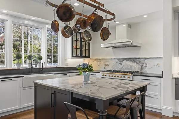 a kitchen with a table a sink and cabinets