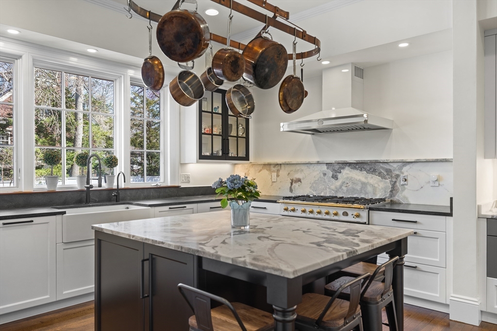 355 Buckminster Road Brookline, MA 02445 - Photo 4 of 32 a kitchen with a table a sink and cabinets