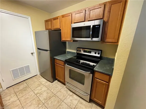 a kitchen with a stove microwave and refrigerator